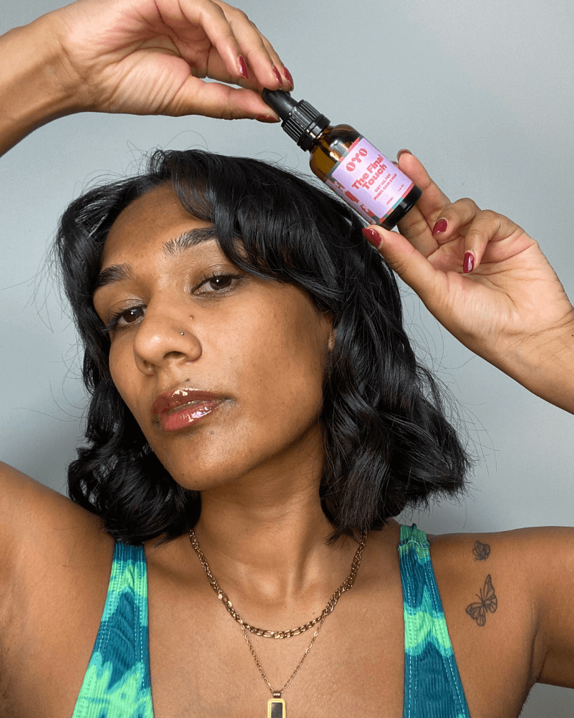 Woman holding a natural skincare serum, promoting effective skincare for all skin types and irritation-free routines.