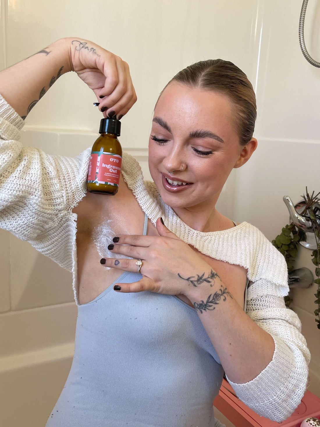 Woman applying natural skincare oil for effective care in intimate areas, promoting soft, nourished skin with clean ingredients.
