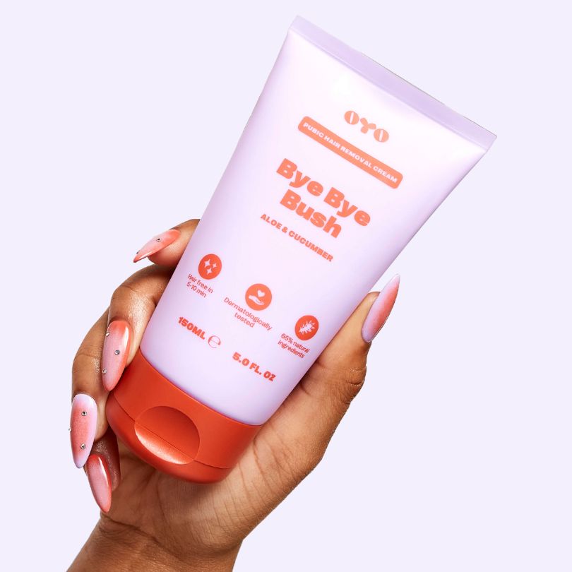 Hand holding OYO Bye Bye Bush cream with aloe & cucumber, ideal for soothing intimate skincare and handling irritation.