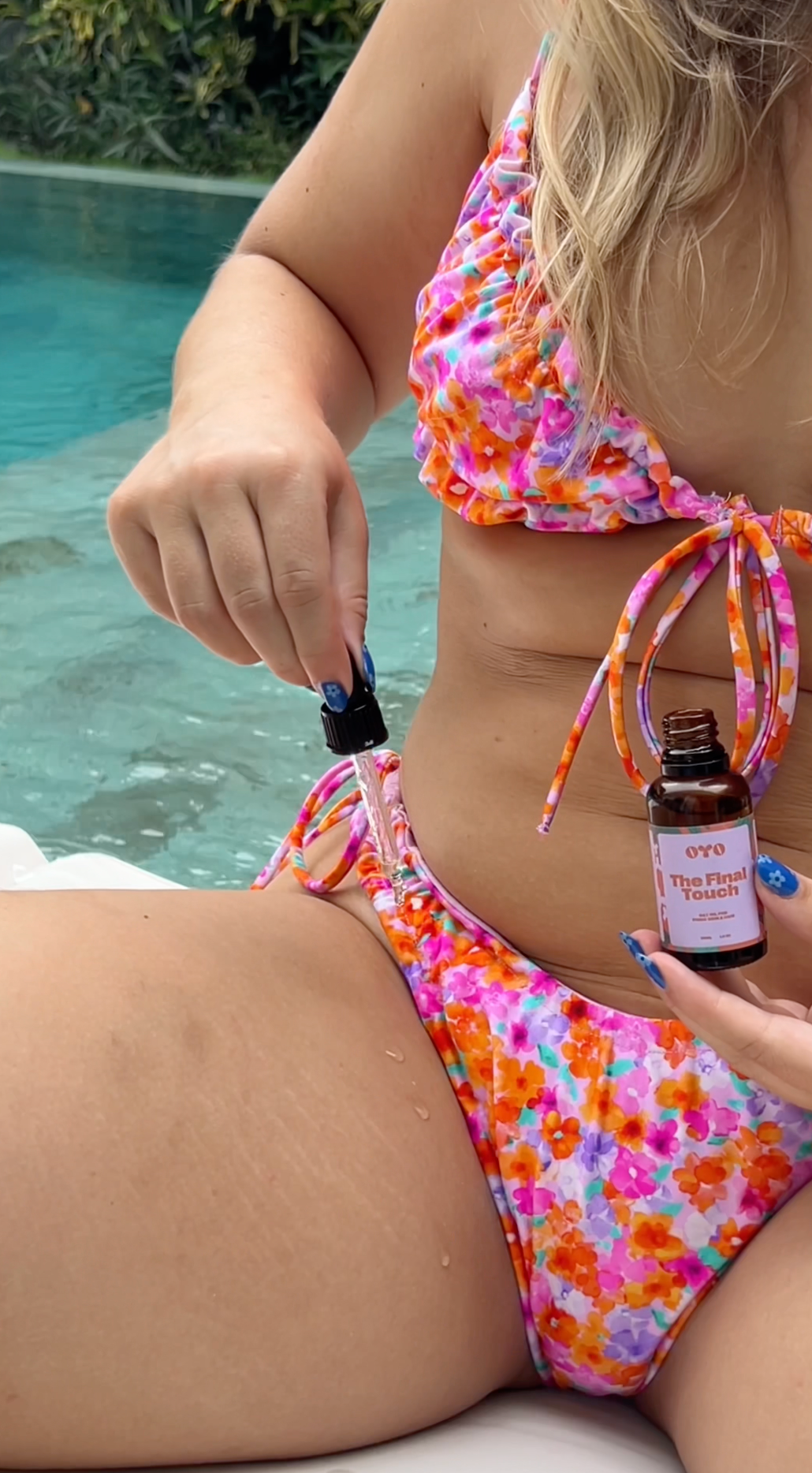 Applying natural skincare oil for intimate areas by the pool, promoting smooth, irritation-free skin.