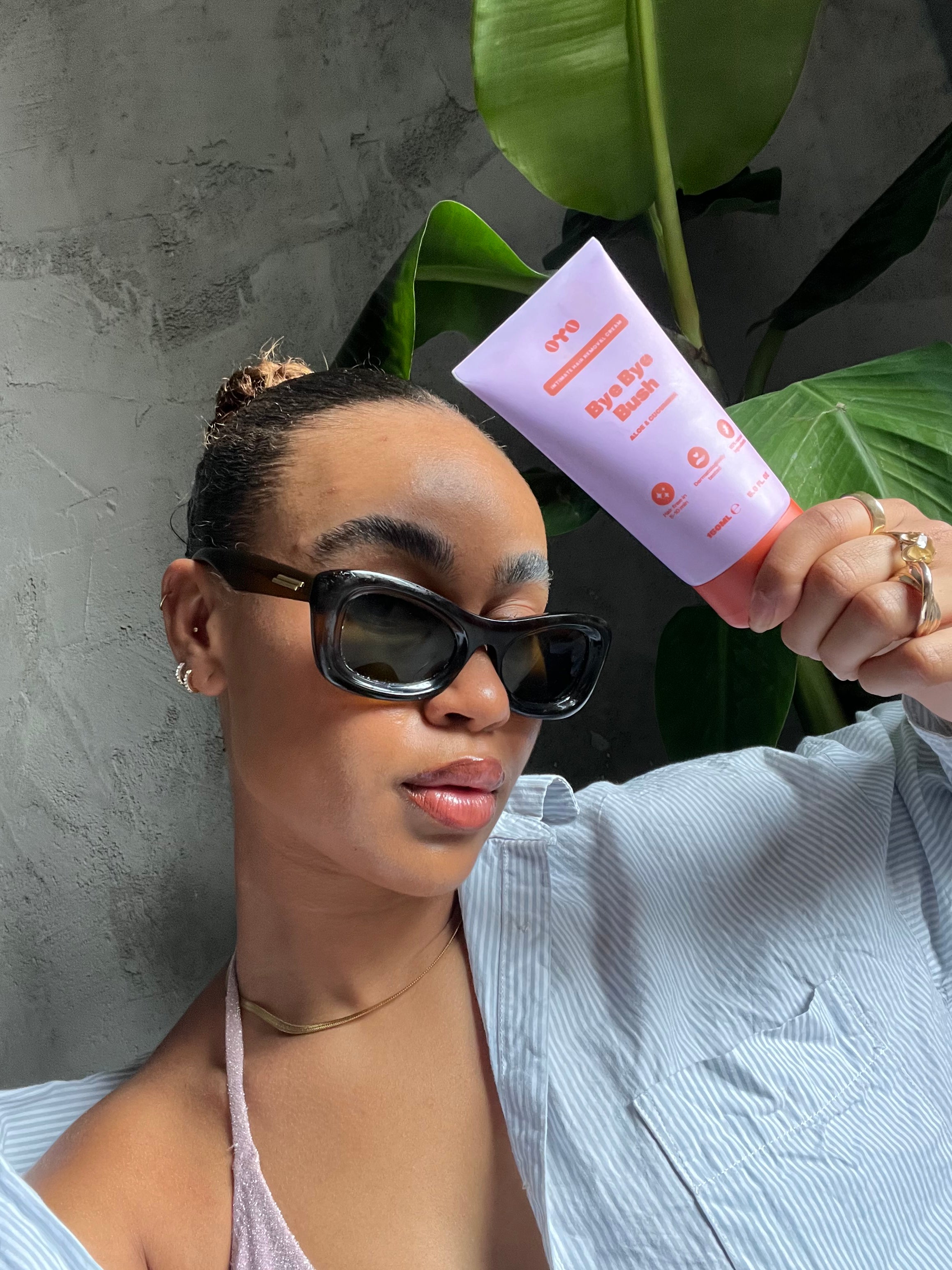 Woman holding natural skincare for sensitive areas, promoting irritation-free skin and trusted by 100k+ women.