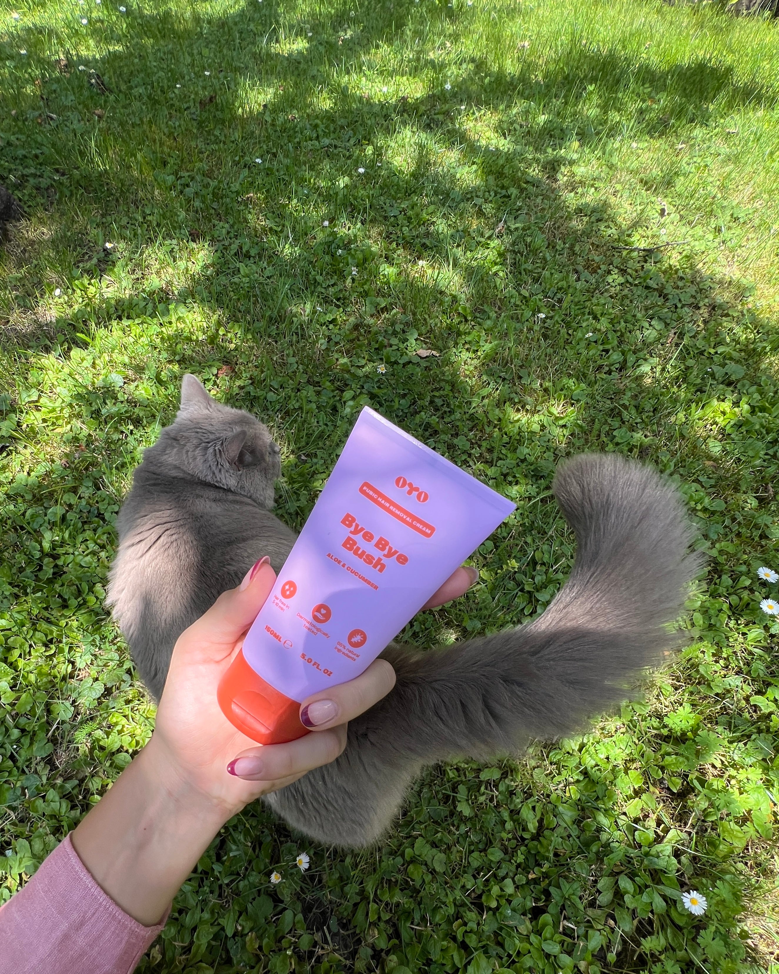 Natural skincare lotion for sensitive areas, safe for all skin types, with a soft kitty in the background enjoying the outdoors.