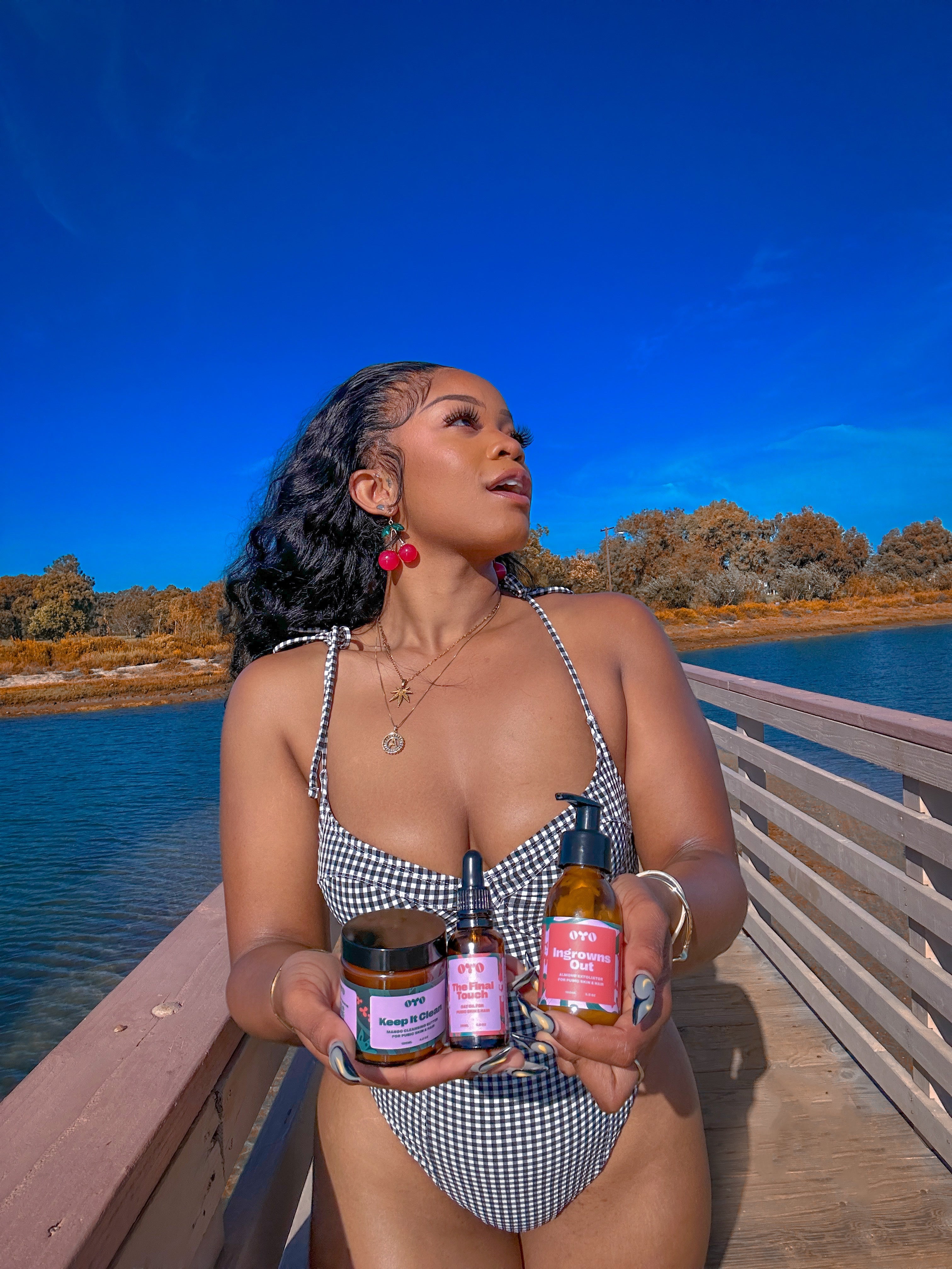 Confident woman by water, showcasing natural skincare products for effective routines, trusted by 100k+ women.